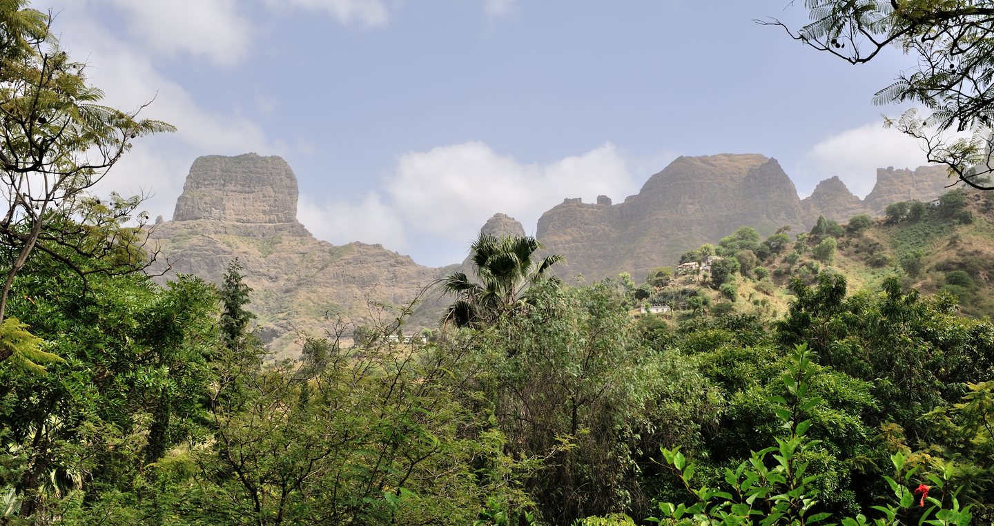 Rocky mountain formations above trees and green vegetation, seen from the botanical garden at São Jorge dos Órgãos